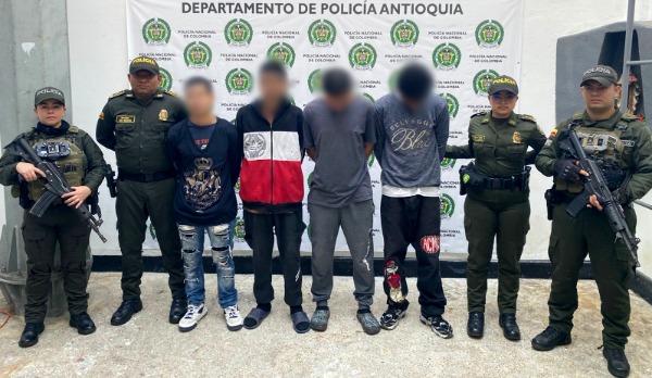 Cuatro policías del GAULA custodian a cuatro capturados