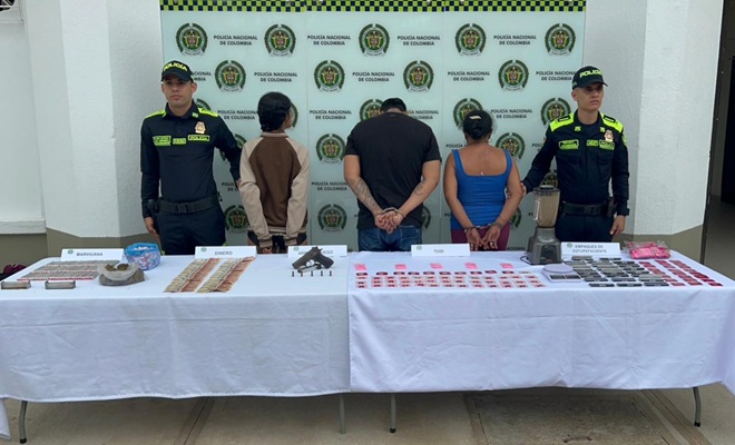 Dos uniformados con tres personas capturadas, con lo elementos incautados entre ellos un arma de fuego, estupefacientes y dinero.