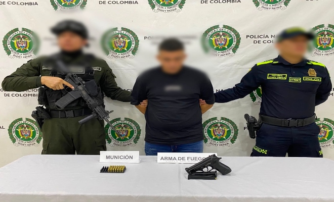 dos uniformados de la Polic&iacute;a nacional con una persona capturada por el delito de porte ilegal de armas de fuego.