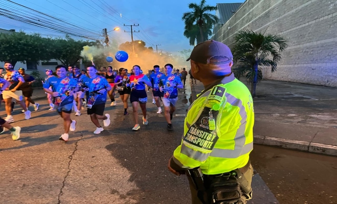 uniformado de transito y transporte garantizando la seguirdad en la carrera 