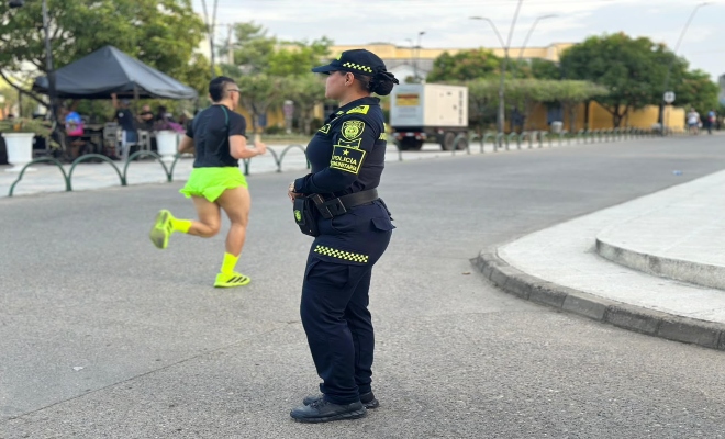 una funcionaria de la Polic&iacute;a Nacional prestando seguridad a los corredores de la carrera que se llev&oacute;  acabo en el municipio de ceret&eacute;