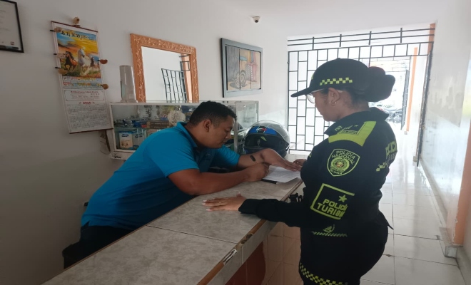 una uniformada realizando la verificacion de los libros en hoteles de la ciudad de Montería 
